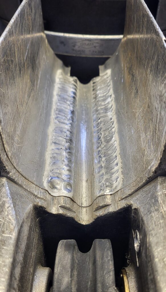 Spacer or "tunnel" wear from rubbing on strand repaired by Tig welding.  New parts cost over $300.